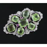 A mid 20th century pierced white gold, peridot, ruby and diamond set shaped oval brooch, set with