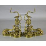 A pair of Louis XVI style ormolu chenets, modelled as urns mounted with scrolling floral foliage,