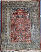 A Tabriz silk rug, on a russet ground, with multi row border, 5ft 9in by 4ft 6in.