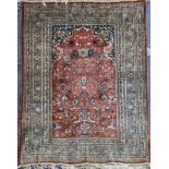 A Tabriz silk rug, on a russet ground, with multi row border, 5ft 9in by 4ft 6in.