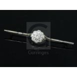 An 18ct white gold, platinum and nine stone diamond cluster set bar brooch, 7cm.CONDITION: Visible