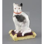 A rare Minton porcelain figure of a cat seated on a cushion, c.1835, H. 12cmCONDITION: