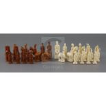 A rare 18th century white and brown walrus ivory Russian chess set, featuring Russians against