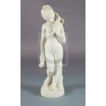 Bouzadou. A carved white marble figure of a nude girl feeding a sheath of corn to a bird