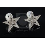 A modern pair of Theo Fennell 18ct white gold and diamond chip encrusted pierced double star