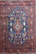 A Kashan blue ground rug, with foliate field and multi row border, 6ft 8in by 4ft 5in.