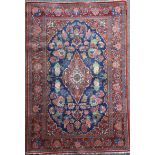 A Kashan blue ground rug, with foliate field and multi row border, 6ft 8in by 4ft 5in.