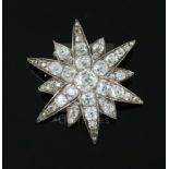 A Victorian gold, silver and old mine and cushion cut diamond set starburst pendant brooch, the