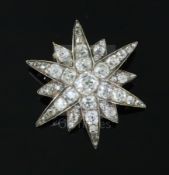 A Victorian gold, silver and old mine and cushion cut diamond set starburst pendant brooch, the