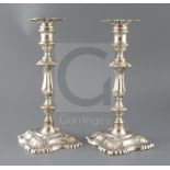 A pair of late Victorian silver candlesticks by William Hutton & Sons Ltd, with waisted knopped