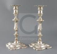 A pair of late Victorian silver candlesticks by William Hutton & Sons Ltd, with waisted knopped