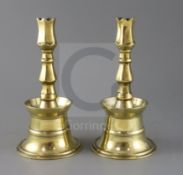 A pair of 17th century Ottoman brass bell based candlesticks, H.9in.