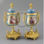 A pair of 19th century French ormolu mounted Sevres style porcelain urns, with jewelled