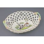 A large Derby oval basket, c.1760, the centre painted with exotic birds in a landscape, the exterior