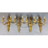 A set of four Adam revival ormolu twin branch wall lights, with flaming urn backplates and foliate