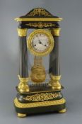 A mid 19th century French bronze and ormolu portico clock, of ornate architectural form, decorated