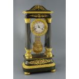 A mid 19th century French bronze and ormolu portico clock, of ornate architectural form, decorated