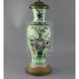 A Chinese famille verte lime green ground vase, late 19th century, painted with Hundred Antiques,