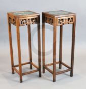 A pair of Chinese hardwood vase stands, each inset with cloisonne panels depicting birds on a branch