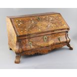 A late 18th century Dutch walnut and marquetry table top bureau, the fall enclosing a pigeon hole