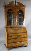 An 17th/18th century walnut bureau bookcase, with broken arch cornice and two astragal glazed