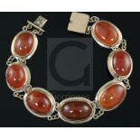 A late Victorian gold and cabochon agate set bracelet, set with seven graduated oval stones, approx.