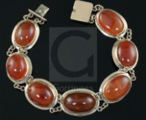 A late Victorian gold and cabochon agate set bracelet, set with seven graduated oval stones, approx.