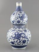 A Chinese blue and white 'dragon and phoenix' double gourd vase , Qianlong mark but late 19th/