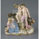 A Meissen porcelain group of the drunken Silenus, 19th century, supported by Bacchus and slumped