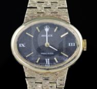 A lady's 1970's 9ct gold Rolex Precision manual wind wrist watch, with black oval dial, on