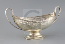 A George III pierced silver two handled boat shaped pedestal fruit bowl, by Henry Chawner, with