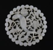 A fine Chinese white jade disc, 18th/19th century, reticulated and carved with a bird amid prunus