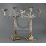 A pair of late Victorian silver corinthian column two branch, three light candelabra by Walker &