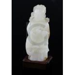 A fine Chinese white and russet jade group of Xi Wangmu and a phoenix, 19th/20th century, the