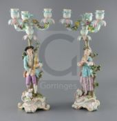 A pair of Meissen bucolic figural candelabra, 19th century, the gentleman figure playing bagpipes