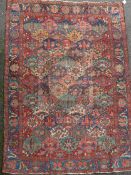 A Bakhtiari red ground carpet, with field of geometric flower heads and foliate border, 10ft 3 x