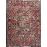 A Bakhtiari red ground carpet, with field of geometric flower heads and foliate border, 10ft 3 x