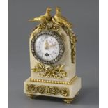 An early 20th century French ormolu mounted white marble desk timepiece, surmounted with two