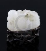 A Chinese white jade group of mandarin ducks, 19th/20th century, each biting lotus tendrils, the