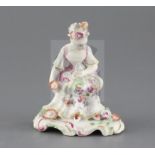 A Derby 'pale family' figure of a seated lady, c.1756, holding flowers in her hands, on a scrollwork