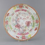 A Chinese export famille rose dish, Yongzheng period, painted with prunus and flowers, within a band