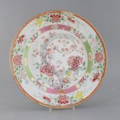 A Chinese export famille rose dish, Yongzheng period, painted with prunus and flowers, within a band