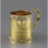 A George III silver gilt mug by Eames & Barnard, with fruiting vine borders and acanthus leaf