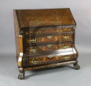 An early 19th century Dutch marquetry inlaid walnut bombe base bureau, the fall enclosing fitted