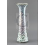 A tall Ruskin high fired vase, dated 1925, decorated with a lilac, lavender, a green speckled glaze,