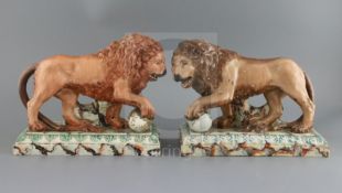 A near pair of large Ralph Wood type pearlware figures of 'Medici' lions, c.1800-10, on faux