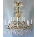 A Louis XV style ormolu and cut glass twenty four light chandelier, with foliate scrolling