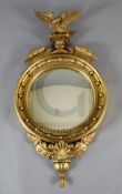 A William IV giltwood and gesso convex wall mirror, with eagle surmount, W.1ft 10in. H.3ft 5in.