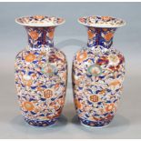A large pair of Japanese Imari baluster vases, densely decorated with birds and flowers, H.