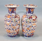 A large pair of Japanese Imari baluster vases, densely decorated with birds and flowers, H.